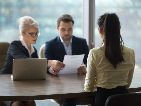 young person in a job interview with two interviewers