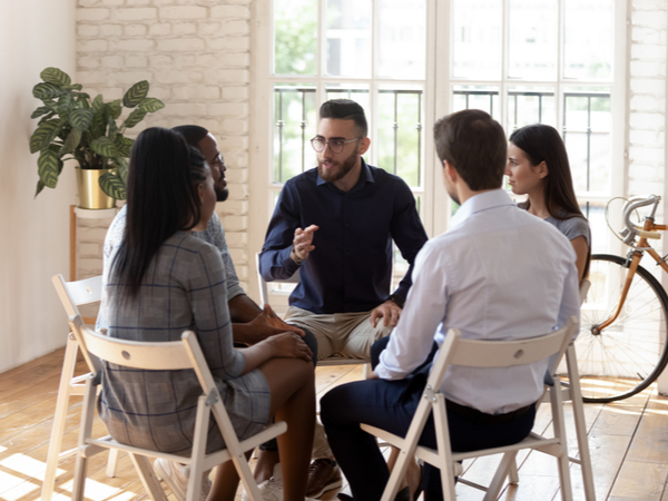 People in a small group meeting close together