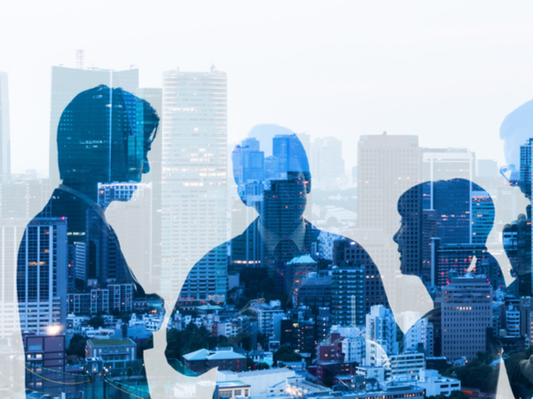 Double exposure of group of business people and cityscape