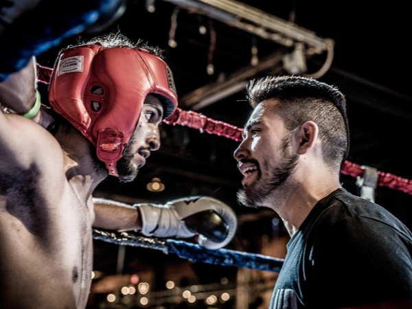 Coach speaking to boxer in the right