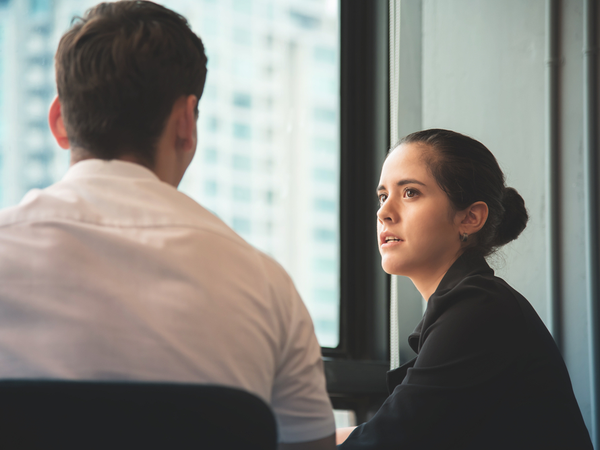 Two people having a conversation at work