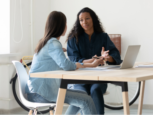 Two women having conversation at work