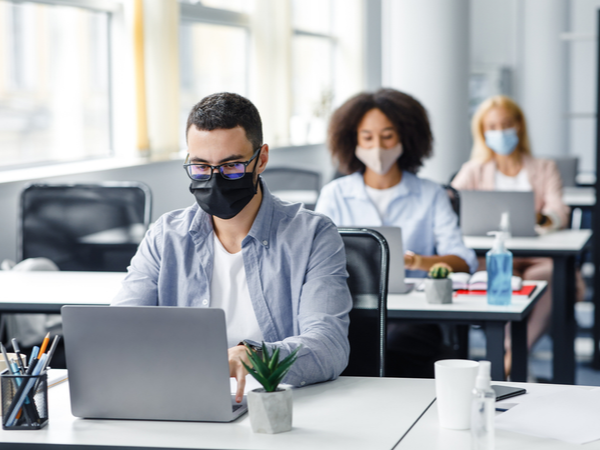 People in their workplace in face masks