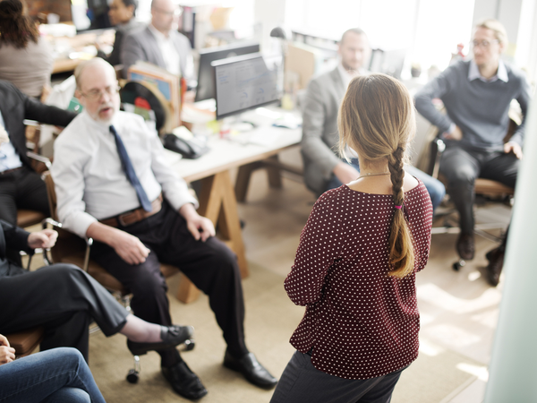 Coach standing in front of employees to give speech