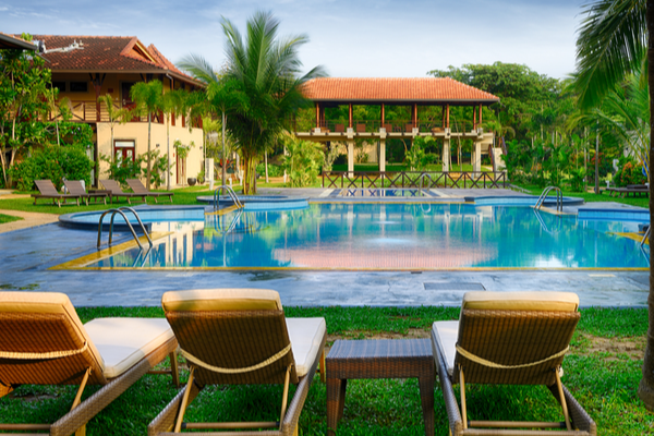 A swimming pool with deckchairs in Sri Lanka