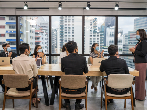 Employees in a meeting wearing face masks