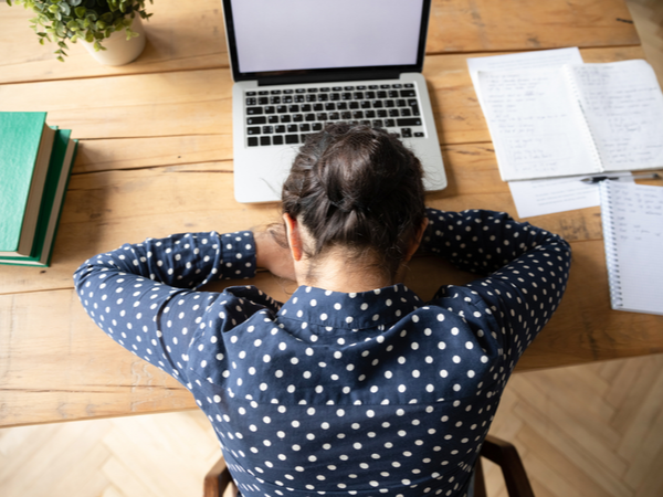 Woman lying down with her head on her desk