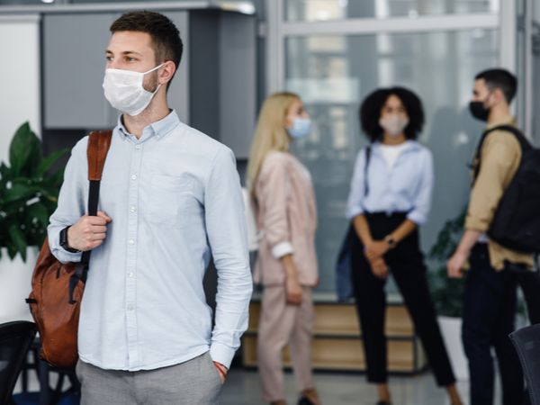 People with face masks on in the workplace