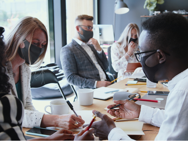 People with face masks on in the workplace