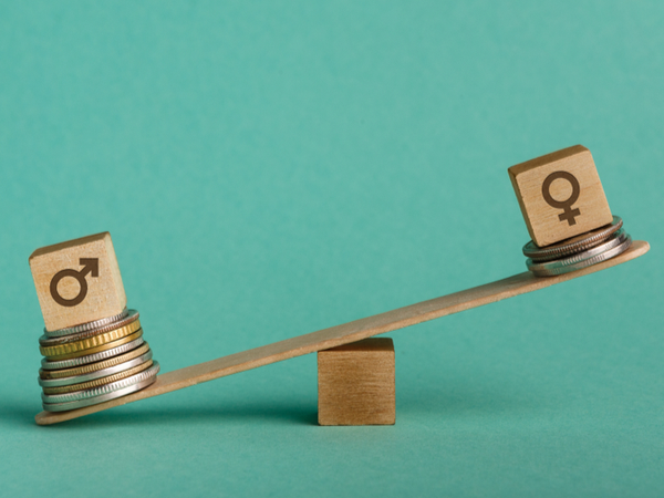 Symbols of two sexes on opposite sides of a seesaw