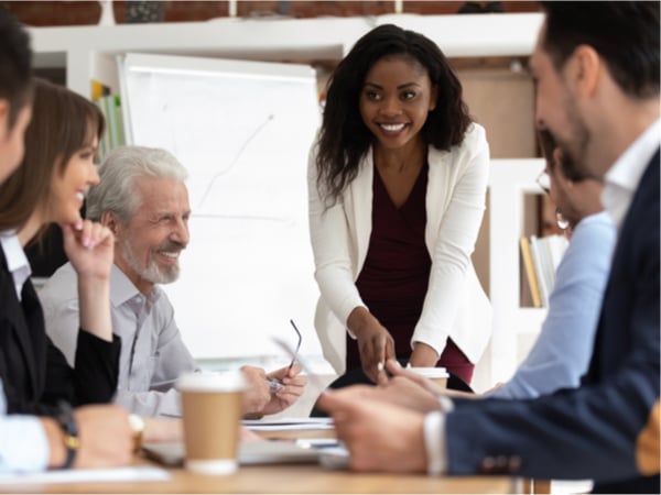 A group of businesspeople gathered together at a boardroom table