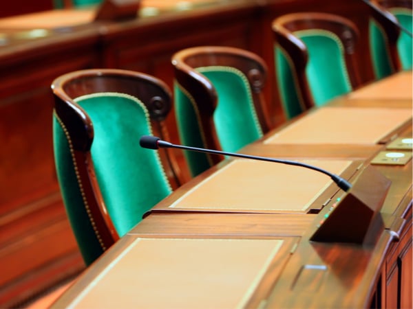 Empty vintage congress hall with seats and microphones