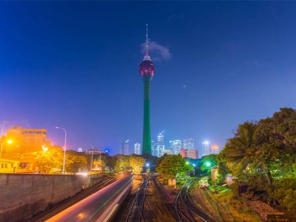 The lotus tower in front of the nighttime Colombo skyline in Sri Lanka