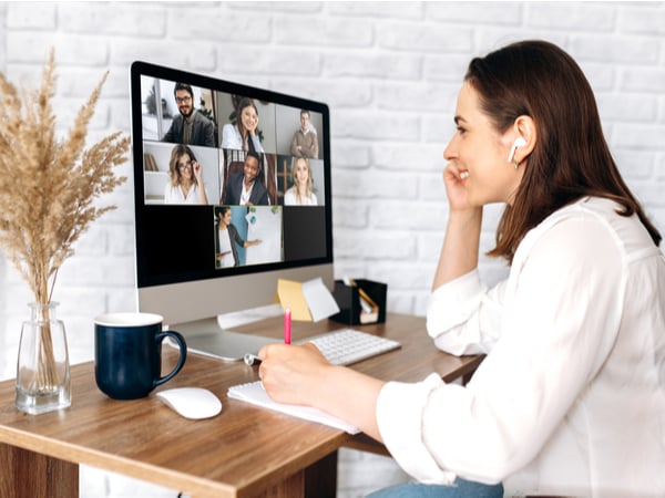 A woman smiling on a team video call