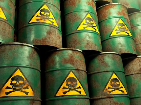 A stack of green barrels with a skull and crossbones on them