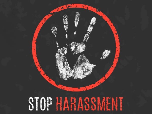 A handprint above the words stop harassment