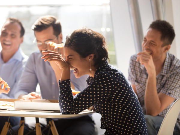 A group of business people laughing in an office