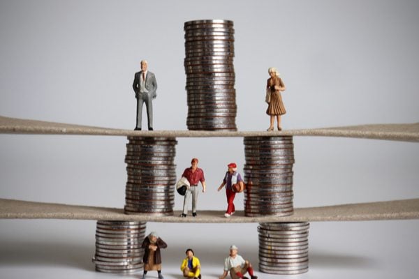 A pyramid of coins with people standing at each level