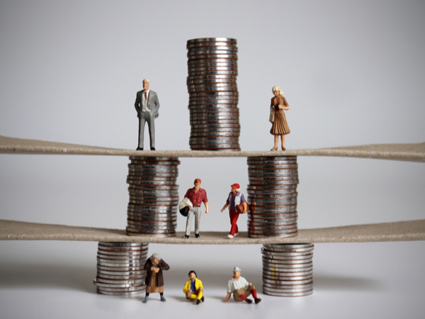 A pyramid of coins with people standing at each level