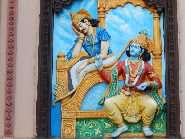 An artwork showing the Hindu figures Krishna and Arjuna talking