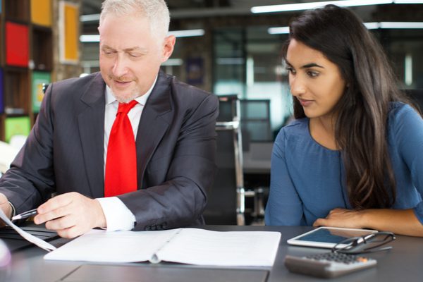 A businessman teaching an apprentice