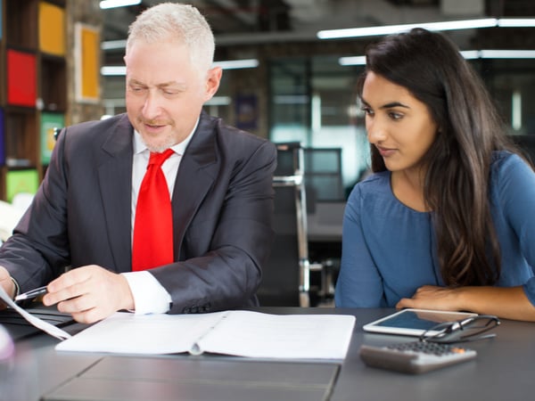 A businessman teaching an apprentice