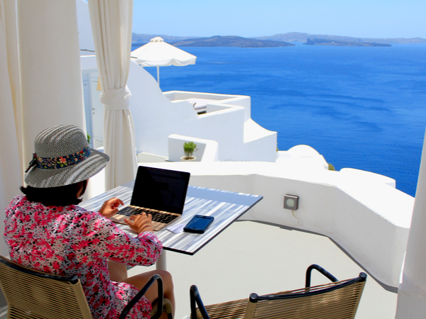 A woman working on a laptop in a hotel on a Greek Island