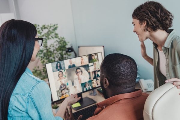 A group of colleagues in a hybrid meeting