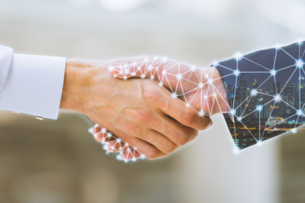 Two people shaking hands, one human and one superimposed with futuristic network nodes