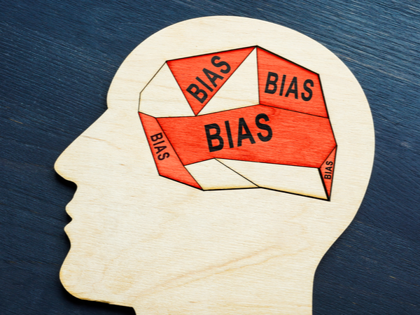 A wooden head with the words 'bias' written inside it