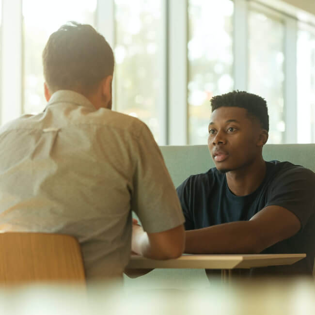 An image of two men talking