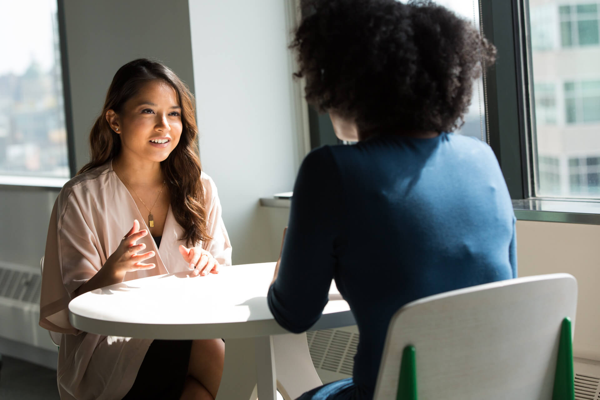 A photo of two women talking