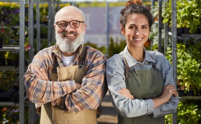 An old and young colleague standing next to each other