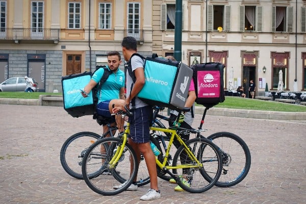 A group of Deliveroo riders on bicyles