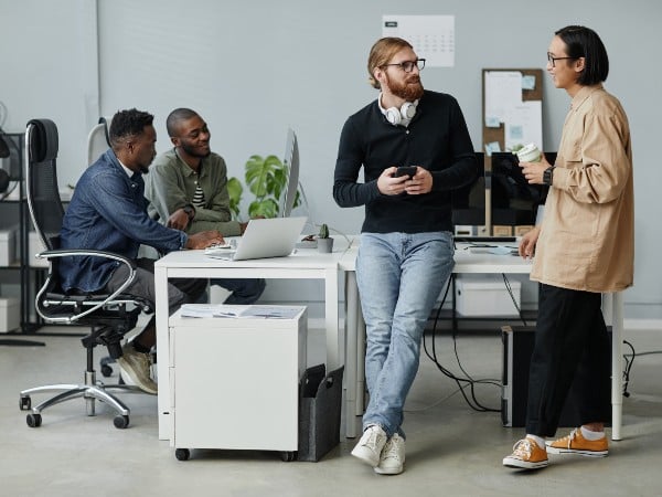 A group of colleagues chatting in an office