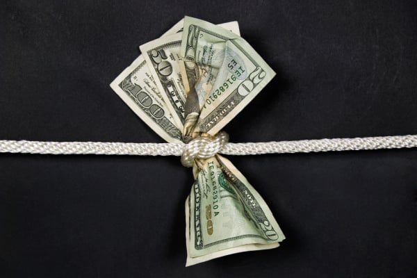 Banknotes bunched together by a knotted rope