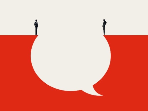 Two people standing either side of a speech bubble