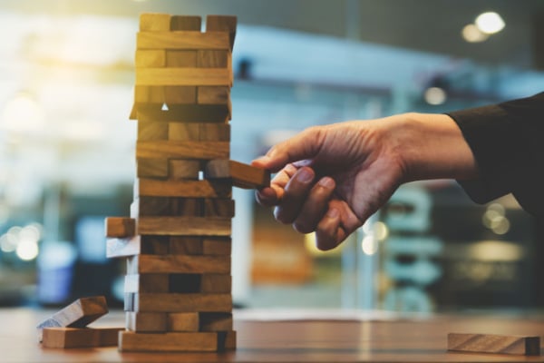 Image pulling a piece out of a jenga tower