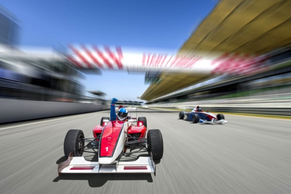 An F1 driver celebrating reaching the finish line