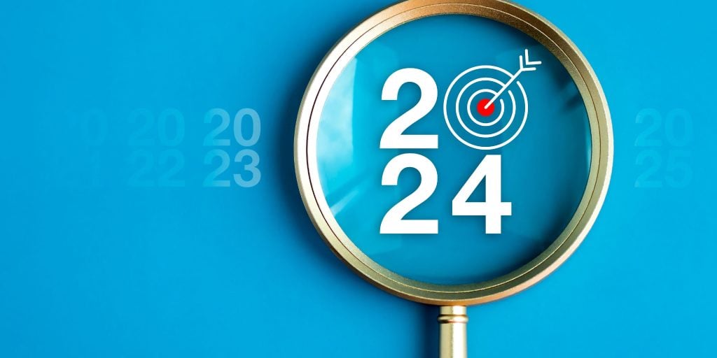A magnifying glass highlighting the words '2024'