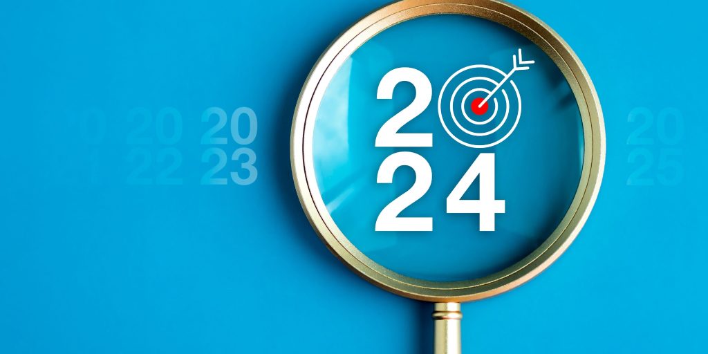 A magnifying glass highlighting the words '2024'