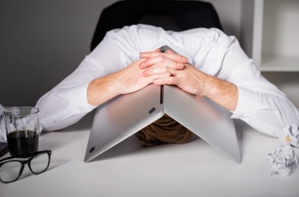 A man frustrated by his work at his desk