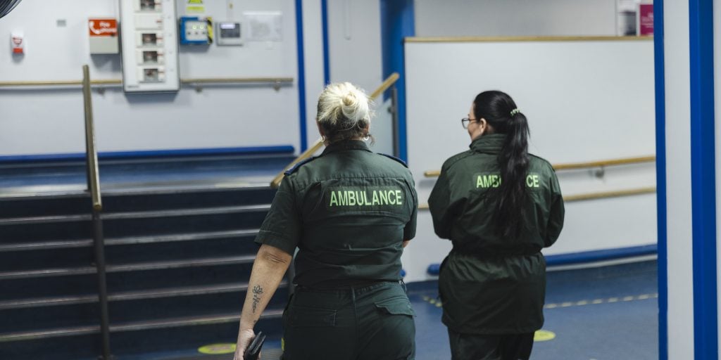 Two paramedics walking through a corridor