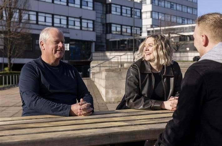 Multigenerational colleagues conversing outside