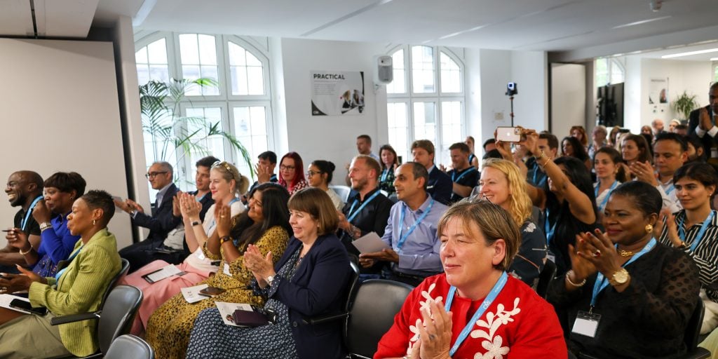 A crowd of people listening to a talk