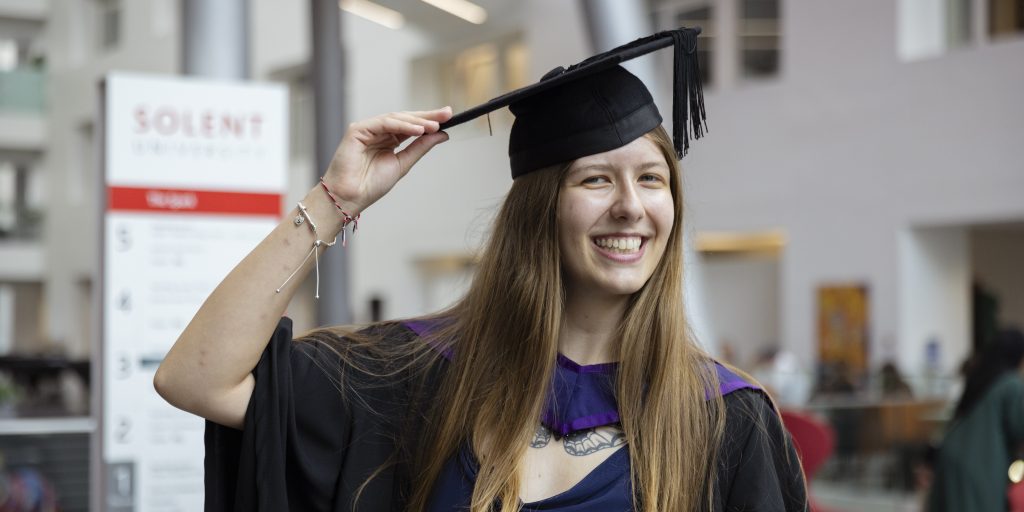 A graduate smiling