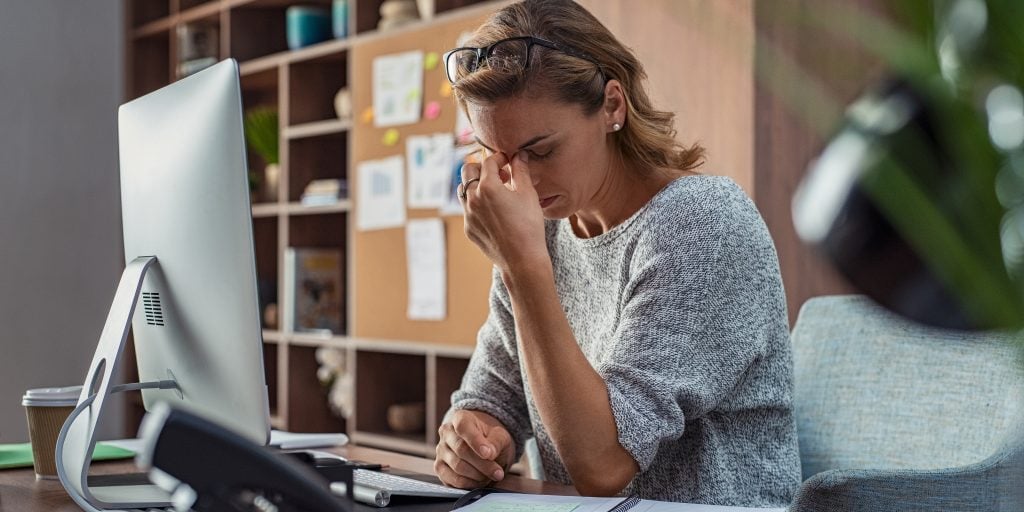 A woman stressed at her desk
