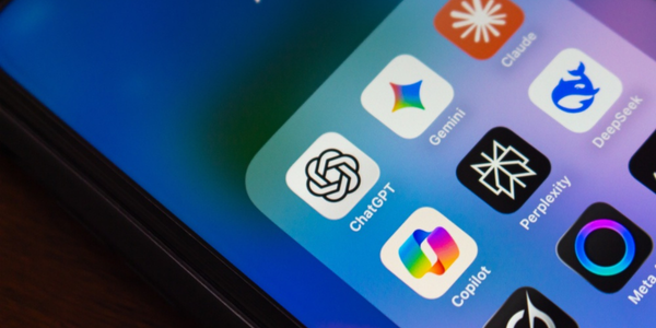 Close-up of an iPhone screen showing an "AI" app folder containing ChatGPT, Gemini, Claude, DeepSeek, Perplexity, Copilot, Meta, and Grok icons