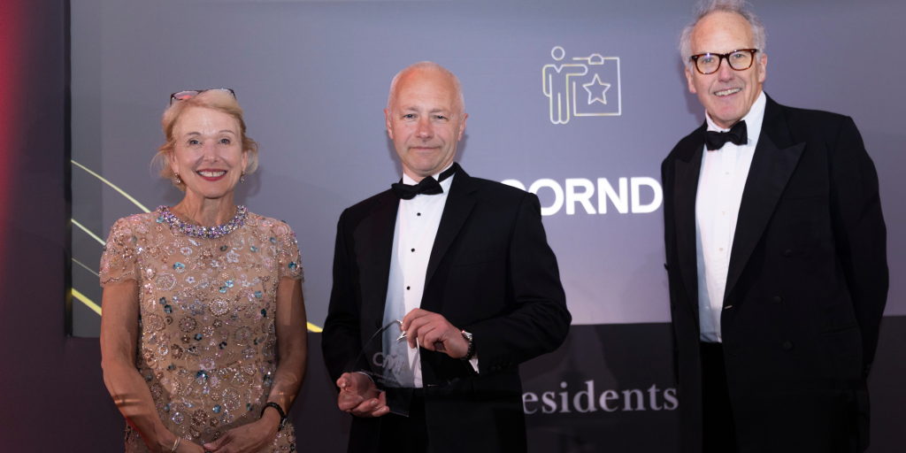 A representative from Corndel collecting their award