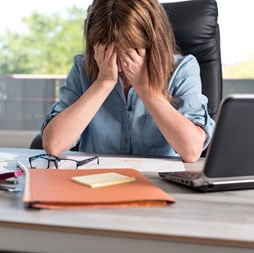 Stressed woman at desk